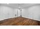 Bedroom with hardwood floors, white walls, and multiple closets at 624 Great Pine Way, Raleigh, NC 27614