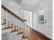 Bright foyer with hardwood floors, a staircase with carpeted steps, and a frosted glass door at 624 Great Pine Way, Raleigh, NC 27614