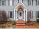 Inviting front exterior of a two-story home with a covered entryway and brick walkway at 624 Great Pine Way, Raleigh, NC 27614