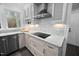 Modern kitchen with white brick backsplash, stainless steel appliances, and sleek countertops at 624 Great Pine Way, Raleigh, NC 27614