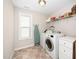 Bright laundry room with washer, dryer, and ample shelving at 78 N Porcenna Ln, Clayton, NC 27527