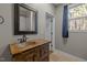 Rustic bathroom with copper sink, wooden vanity, and window at 7815 Dodsons Crossroads, Hillsborough, NC 27278