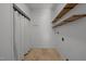 Bright laundry room with built-in shelves and tile floor at 7815 Dodsons Crossroads, Hillsborough, NC 27278