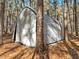 White canvas shed nestled amongst the trees at 7815 Dodsons Crossroads, Hillsborough, NC 27278