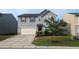 Inviting front yard with a paved driveway, green lawn, and a two-story house at 8008 Matinvesi St, Raleigh, NC 27616