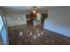 Open-concept living and dining area with hardwood floors and view of the kitchen at 8008 Matinvesi St, Raleigh, NC 27616