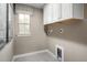 Well-appointed laundry room with upper cabinets and window at 8861 Tartan Clan Dr, Willow Springs, NC 27592