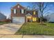 Brick two-story house with a lit-up front entrance and a well-kept lawn at dusk at 900 Blue Thorn Drive Dr, Apex, NC 27539