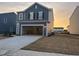 Two-story house with gray siding, attached garage, and landscaping at 109 N Keatts Winner Ct, Clayton, NC 27520