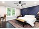 Bright bedroom with a large window, ceiling fan, and dark wood floors at 13001 Norwood Rd, Raleigh, NC 27613