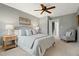 Bright bedroom with ceiling fan and ensuite bathroom access at 1402 Mahonia Ct, Raleigh, NC 27615