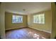 Spacious bedroom with hardwood floors and two large windows at 1615 Carbonton Rd, Sanford, NC 27330