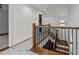 Upstairs hallway with a wooden staircase and modern light fixture at 1811 Bellemont Alamance Rd, Burlington, NC 27215