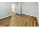 Spacious bedroom with wood-look floors and access to hallway at 203 Pond Vw Ct # 1, Fuquay Varina, NC 27526