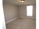 Empty bedroom with carpeting, a window, and neutral-colored walls at 204 Willoughby Ln, Cary, NC 27513