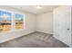 Spacious bedroom featuring neutral walls, carpeting, and large windows with a view at 207 Pond View Ct # 3, Fuquay Varina, NC 27526