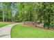 A paved walkway meanders through a green, tree-lined community space at 209 Pond View Ct # 4, Fuquay Varina, NC 27526