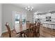 Dining area with a wooden table, chairs, and access to the backyard at 2375 Nc Highway 96, Four Oaks, NC 27524