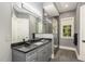 Elegant bathroom with dark countertop and a frameless shower at 25303 Ludwell, Chapel Hill, NC 27517