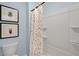 Small bathroom with a shower/tub combo and colorful shower curtain at 255 Moore Creek Dr, Fuquay Varina, NC 27526