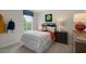 Cozy bedroom with a twin-sized bed and black and white bedding at 255 Moore Creek Dr, Fuquay Varina, NC 27526
