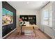Bright home office with large artwork, built-in shelves, and a desk at 255 Moore Creek Dr, Fuquay Varina, NC 27526