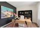 Bright home office with large artwork, built-in shelves, and a desk at 255 Moore Creek Dr, Fuquay Varina, NC 27526