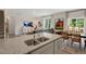 Kitchen boasts a large island with granite countertops and stainless steel sink at 255 Moore Creek Dr, Fuquay Varina, NC 27526