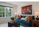 Cozy living room featuring a teal sofa and large artwork at 255 Moore Creek Dr, Fuquay Varina, NC 27526