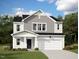 Two-story home with neutral siding and a two-car garage at 268 Babbling Brook Dr, Clayton, NC 27520