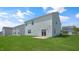 View of the home's back and side with a grassy yard at 273 Hanging Elm Ln, Fuquay Varina, NC 27526