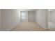 Spacious bedroom with neutral carpeting and large window at 273 Hanging Elm Ln, Fuquay Varina, NC 27526