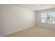 Well-lit bedroom featuring neutral walls and carpeted floors at 273 Hanging Elm Ln, Fuquay Varina, NC 27526