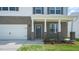 Gray front door entry with brick columns and landscaping at 273 Hanging Elm Ln, Fuquay Varina, NC 27526
