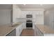 Spacious kitchen with stainless steel appliances and granite counters at 273 Hanging Elm Ln, Fuquay Varina, NC 27526