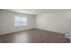 Bright living room with wood-look floors and view to backyard at 273 Hanging Elm Ln, Fuquay Varina, NC 27526