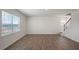 Light-filled living room with wood floors and backyard view at 273 Hanging Elm Ln, Fuquay Varina, NC 27526