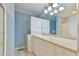 Bathroom with light blue walls, a vanity, and stacked washer/dryer at 304 Homestead Rd. Rd, Chapel Hill, NC 27516