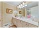 Bathroom with double vanity, beige cabinets, and a large mirror at 304 Homestead Rd. Rd, Chapel Hill, NC 27516