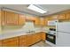 Small kitchen with wood cabinets and standard appliances at 304 Homestead Rd. Rd, Chapel Hill, NC 27516