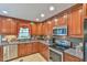 Kitchen with wood cabinets, granite countertops, and stainless steel appliances at 304 Homestead Rd. Rd, Chapel Hill, NC 27516