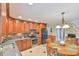 Eat-in kitchen with wood cabinets, granite countertops, and stainless steel appliances at 304 Homestead Rd. Rd, Chapel Hill, NC 27516