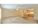 Open living room and kitchen with neutral carpet and ceiling fans at 304 Homestead Rd. Rd, Chapel Hill, NC 27516