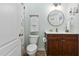 Clean bathroom with white countertop, wooden cabinets, and modern fixtures at 3805 Hamlin Ct, Raleigh, NC 27616