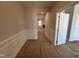 Bright hallway with white wainscoting and access to other rooms at 453 Edison Rail Ln, Knightdale, NC 27545