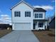 Two-story white house with gray shutters, double garage, and landscaping at 4900 Pioneer Dr, Sanford, NC 27330