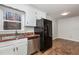 Updated kitchen with white cabinets and stainless steel appliances at 5612 Plum Nearly Ct, Raleigh, NC 27610