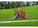 Wooden playground structure with two slides at 708 Longleaf Grove Ln # Virginia104, Knightdale, NC 27545