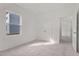 Well-lit bedroom with double door closet and access to a hallway at 7305 Pilatus Ave, Spring Hope, NC 27882