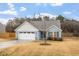 Two-car garage and front yard with landscaping at 88 Norris Farm Dr, Angier, NC 27501